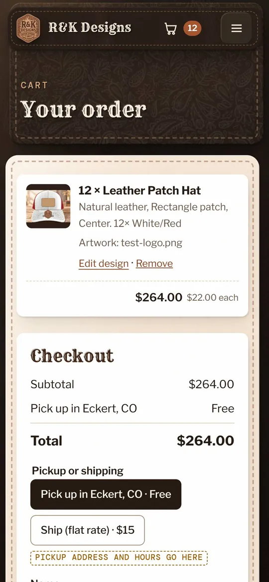 The cart on a phone: 12 leather patch hats in White/Red with the uploaded artwork file, an Edit design link, and pickup in Eckert or flat-rate shipping